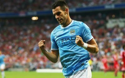 Alvaro Negredo celebrates scoring against Bayern Munich