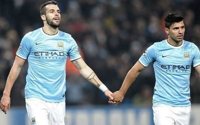 Sergio Aguero and Alvaro Negredo link hands whilst playing for Manchester City.